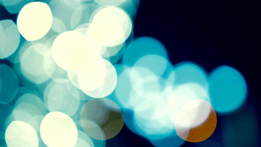 Craneement of beautiful colored bokeh, the lights making abstract colored bokeh like galaxy, yellow and blue light circle, the cameraing up. | Shutterstock HD Video #1085794451