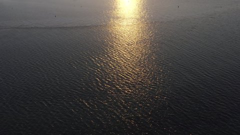 Golden Sun Reflecting On The Waters Of Ria Formosa Lagoon In Algarve, Portugal At Sunset. aerial tilt-up