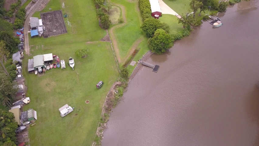 Top down aerial fly over a camping site next to a river at Gold Coast, Queensland Australia