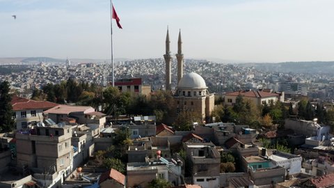 Flock Of Birds Flying Ovr The Gaziantep Old Town With Turktepe Cami And Turkish Flag On Flagpole In Istanbul, Turkey. - aerial