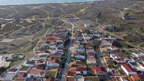 Houses At The Coastline Of Culatra Island. Barrier Island In The Ria Formosa, Algarve Region Of Portugal. aerial pullback