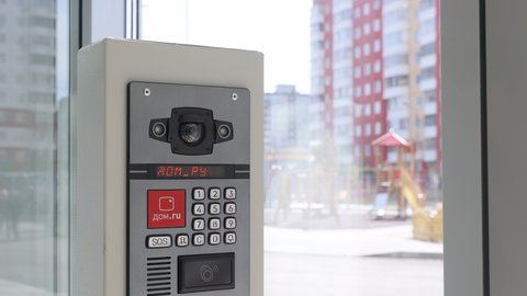 PERM, RUSSIA SEPTEMBER 10, 2021: Video intercom with button panel and NFC access. Smart home system dom.ru . The concept of security