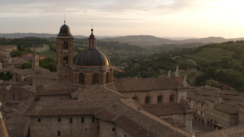 Aerial view of Urbino, Italy, at sunrise. Drone shot flying over old churches and monuments. Place of renaissance heritage. footage in 4K resolution