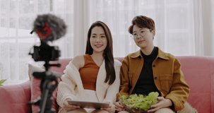 LGBT Couple Blogger Livestream on Camera Talking Salads with Vegetables, Fruits useful good for health. Online work for new generation. Communication via high speed internet. online selling business