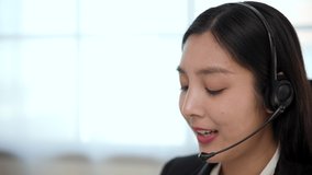 Call center smiley asian business woman receptionist wear headphone video conference calling on computer talk by webcam in online chat, customer support service.