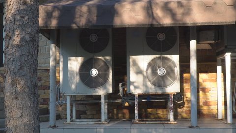 Industrial air conditioning system. Large fans on the wall of the building