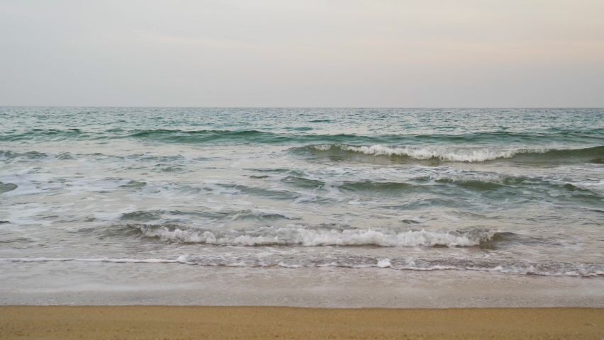 Calming Waves of the Sea on a Relaxing Sunset on a sandy beach, Steady shot
