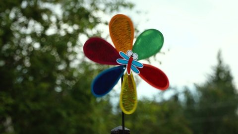 Windmill rotate motion. Colorful weather vane on natural background. air vane  on the move