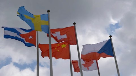 Various national flags with the EU flag under a blue sky
