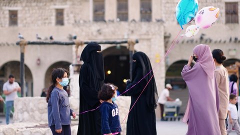 Doha - Qatar - november 2021- Qatari families walking in front Souq Waqif in Doha Qatar
