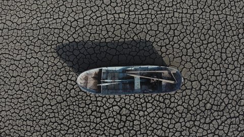 Aerial view of an abandoned fishing boat on a dry lake. Concept of climate change, ecological and environmental disaster of nature. 