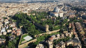 Aerial drone video of Saint Peter's gardens of world's largest church -Basilica of St. Peter's, Vatican and iconic Capella Sistine, Rome, Italy