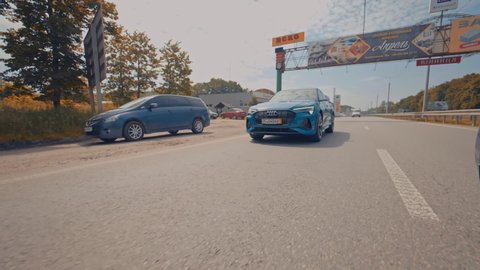 KYIV, UKRAINE - August 2021: Electric metallic blue Audi e-tron 55 quattro SUV. Audi e tron, a fully electric car on highway