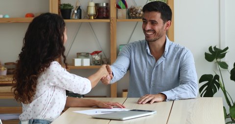 Confident Hispanic female applicant pass job interview, finish formal appointment shake hands with company HR manager. Successful business meeting, making deal, human resources, recruitment concept