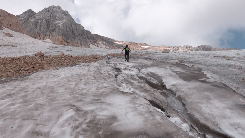Scenic mountain pass near Fisht Mount, Adygea, Russia. A man in trekking in the mountine. Caucasian State Natural Biosphere Reserve named after Kh.G. Shaposhnikov. Lago-Naki plateau. Russia.