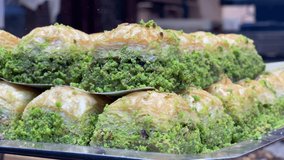 Turkish baklava with pistachio made up of composition Macro detail shot 4K video buying now.