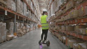 Woman manager or storekeeper works at retail or wholesale warehouse using tablet for inventory control, moving on hoverboard examining at shelves with goods. - Powered by Shutterstock - Get 15% off with code: PIKWIZARD15