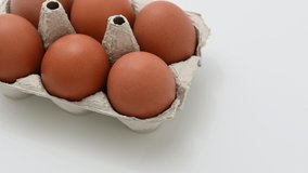 4k 60fps close up video of chicken brown eggs in paper tray