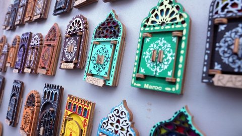 Chefchaouen, Morocco. October 10, 2021. Variety of small wooden door shaped design magnets for sale at local bazaar in Morocco