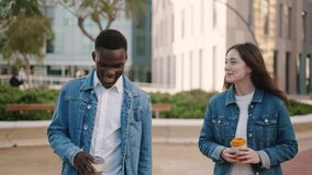Glad multiethnic friends with takeaway coffee walking in city - Powered by Shutterstock - Get 15% off with code: PIKWIZARD15
