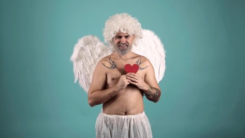 Valentin with heart. Funny crazy man with feathers wings of Cupid Valentines Day.