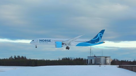 Oslo Airport Norway - January 21 2022: airplane boeing 787 dreamliner norse atlantic airlines arrival landing beautiful winter light ambient sound