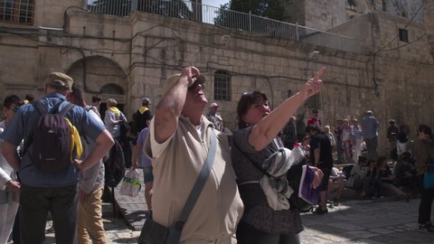 A couple among many other tourists in the courtyard of the Church of the Holy Sepulchre, Jerusalem, Israel - 6 may 2021