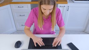 Freelancer woman working online. Young blonde female typing on laptop keyboard. White person doing distant work or education with fast internet connection and notebook pc in 4k stock video