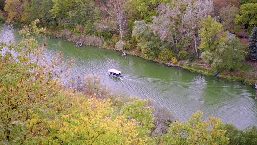 Boat with tent mooves by river