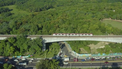 Aerial tracking shot of subway train traveling on elevated line, Santo Domingo