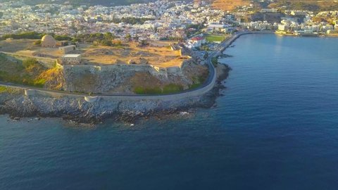 Flying a drone away from Fortezza Rethymno over the Mediterranean sea in Crete Greece