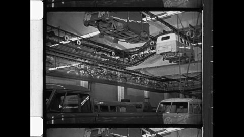 1950 Wolfsburg, Germany. Volkswagen automotive factory. The Body Shell of VW Bus along the assembly line at automotive factory. 4K Overscan of Archival 16mm Newsreel Film Print 