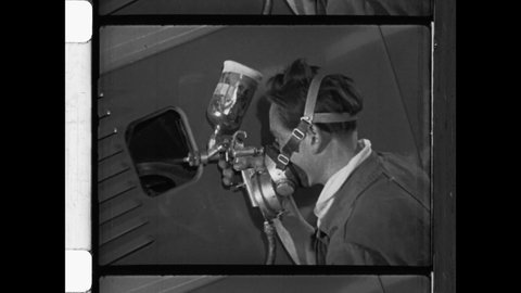 1950 Wolfsburg, Germany. Volkswagen automotive factory.  Factory workers buff, spray and brush paint the body shell of VW Bus, or Volkswagen Transporter. 4K Overscan of Archival 16mm Newsreel 