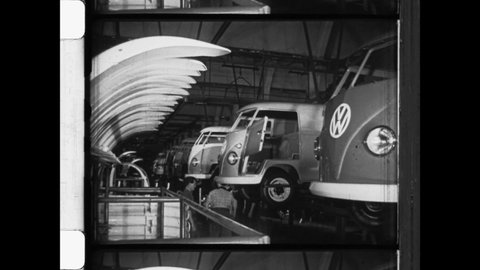 1950 Wolfsburg, Germany. Factory workers assemble the Volkswagen Type 2, or VW Bus on the assembly line at Volkswagen automobile factory. 4K Overscan of Archival 16mm Newsreel Film Print 