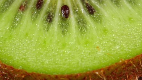 Kiwi fruit slice macro, dolly shot. Low angle