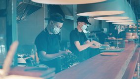 Restaurant workers are cooking food in face masks - Powered by Shutterstock - Get 15% off with code: PIKWIZARD15