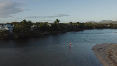 Aerial view of a person paddling with a board at Riviere du Rempart, a river near Baie du Tamarin, a beautiful bay in Mauritius.