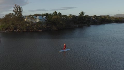Aerial view of a person paddling with a board at Riviere du Rempart, a river near Baie du Tamarin, a beautiful bay in Mauritius.