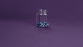 Glass jar with Colorful mixed candies. Сhocolate dragee drop. Purple pack shot background FullHD. Sweet packshot - Powered by Shutterstock - Get 15% off with code: PIKWIZARD15