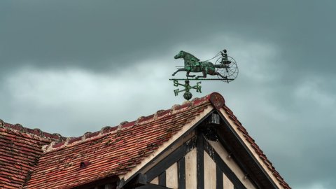 Dramatic stormy clouds moving over rooftops of the village Beuvron-en-Auge, one of the most beautiful villages in France. Beuvron is a commune in the Calvados , Normandy region. Time lapse.