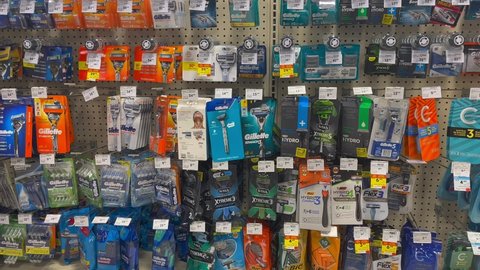 Edmonton, Canada - January 14, 2022: Various brands of razors and shavers on display in a grocery store