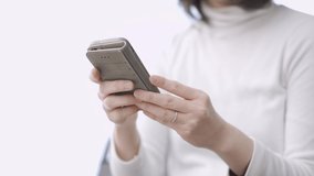Asian female typing text on her smartphone