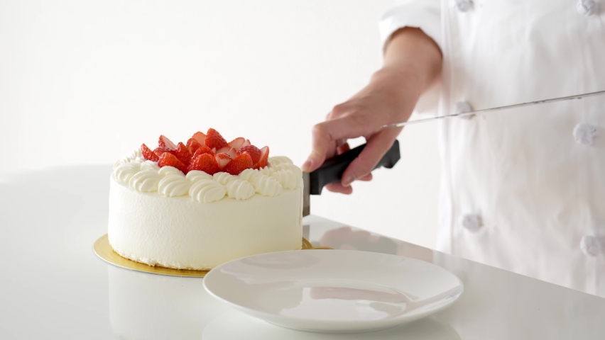 pastry chef serving strawberry cake isolated on white background.