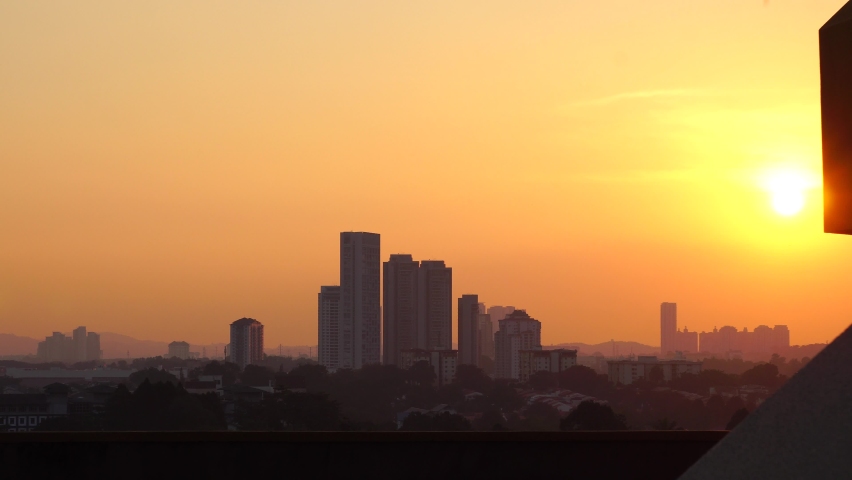 Yellow Sunset panorama over a busy building cityscape. 