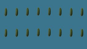 Colorful pattern of fresh cucumbers. Top view. Seamless pattern with cucumber. Pop art design. Realistic animation. 4K video motion