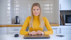 Beautiful white woman opening laptop computer and start working online on lockdown in 4k stock video. Attractive blonde female doing distant work on notebook pc connected to fast internet