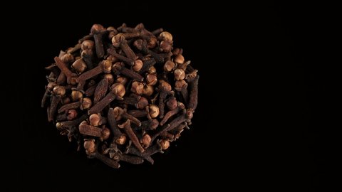 Whole Cloves on black background, rotate. Spice cloves. 4K UHD video