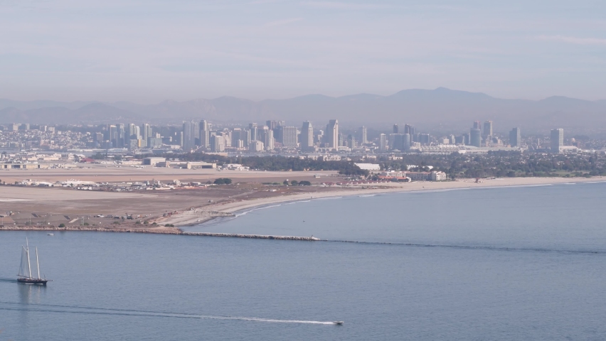 San Diego city skyline, cityscape of downtown with highrise skyscrapers, California coast, USA. View of Coronado island from above, Point Loma vista viewpoint. Frigate sail-powered ship, windjammer.