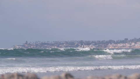 Big blue ocean waves crashing on beach, California pacific coast, USA. Sea water foam and white sand. Summertime shore aesthetic. Surfing vibes, seascape near Los Angeles. Seamless looped cinemagraph.