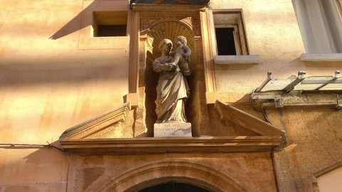 Aix-en-Provence, France - August 2021 : Oratory Virgin and Child, with a crown of roses on the Rue Portalis street in Aix en Provence, France